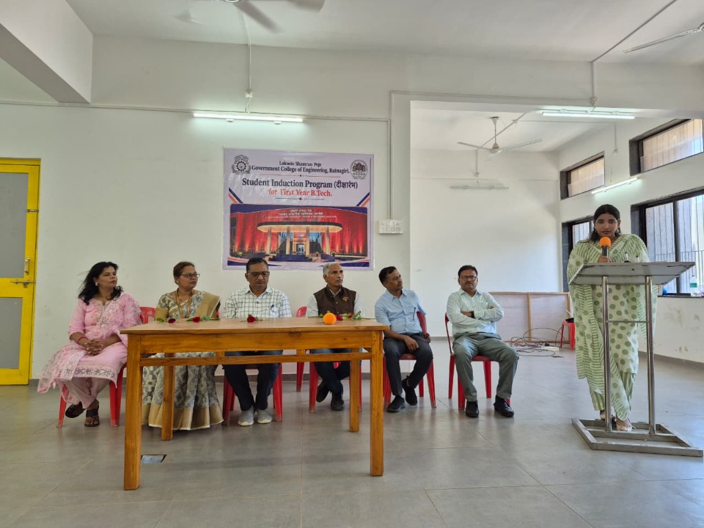 Dignitaries and faculty on the dais with the Student Induction Program (दीक्षारंभ) banner at LSPGCOER Ratnagiri